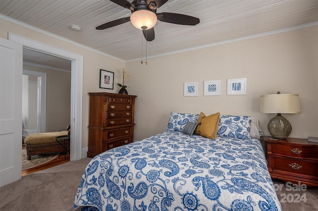 carpeted bedroom featuring ceiling fan and ornamental molding