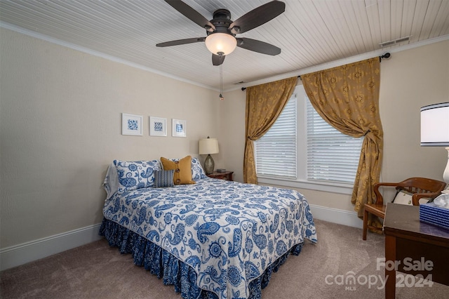 carpeted bedroom with ceiling fan, wood ceiling, and ornamental molding