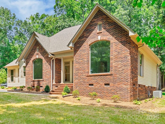 view of front of house featuring a front yard and cooling unit