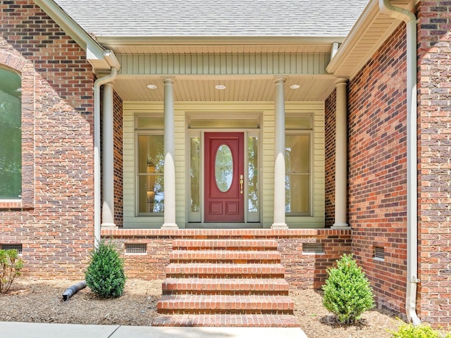 view of exterior entry with a porch