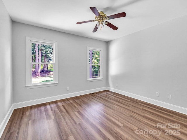 spare room with ceiling fan and hardwood / wood-style flooring