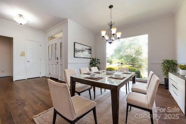 dining room featuring dark hardwood / wood-style flooring, a chandelier, and ornamental molding