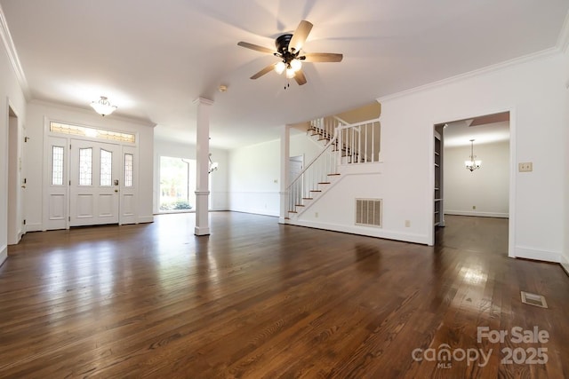 interior space with ceiling fan with notable chandelier, dark wood-type flooring, decorative columns, and ornamental molding