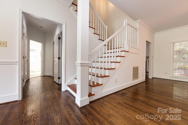 stairway featuring hardwood / wood-style flooring and ornamental molding