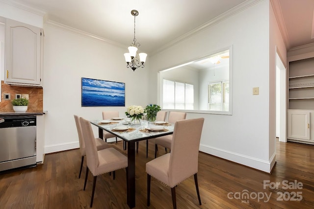 dining area with dark wood-type flooring, ornamental molding, and an inviting chandelier