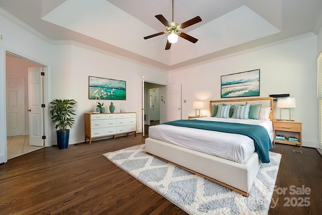 bedroom with ceiling fan, dark hardwood / wood-style flooring, lofted ceiling, and ornamental molding