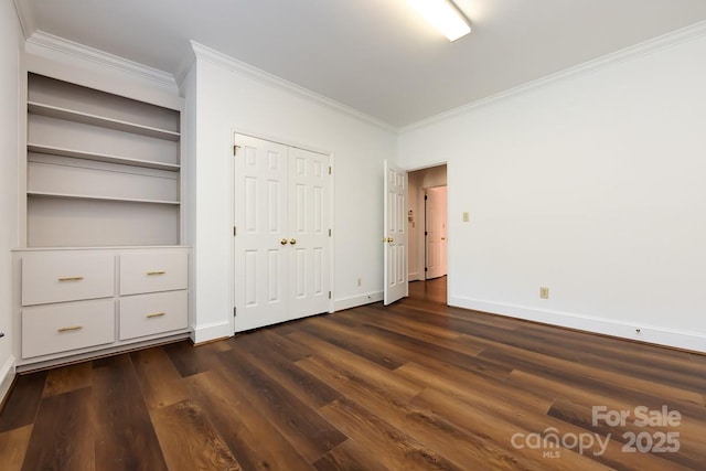 unfurnished bedroom with dark hardwood / wood-style floors and ornamental molding