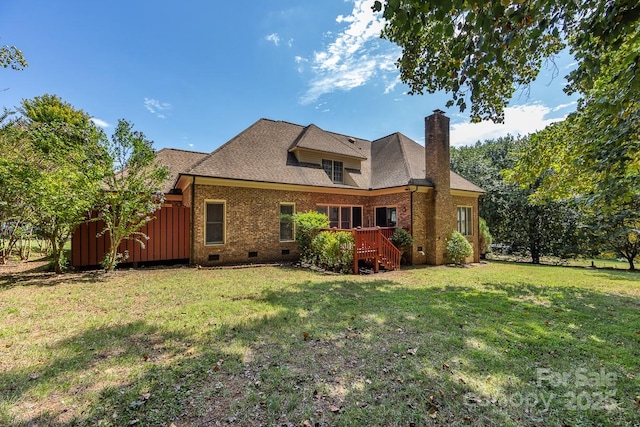 rear view of property featuring a deck and a yard