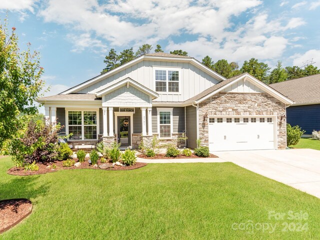 craftsman-style home featuring a garage and a front lawn