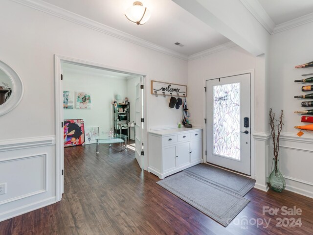 entryway featuring wood-type flooring and ornamental molding