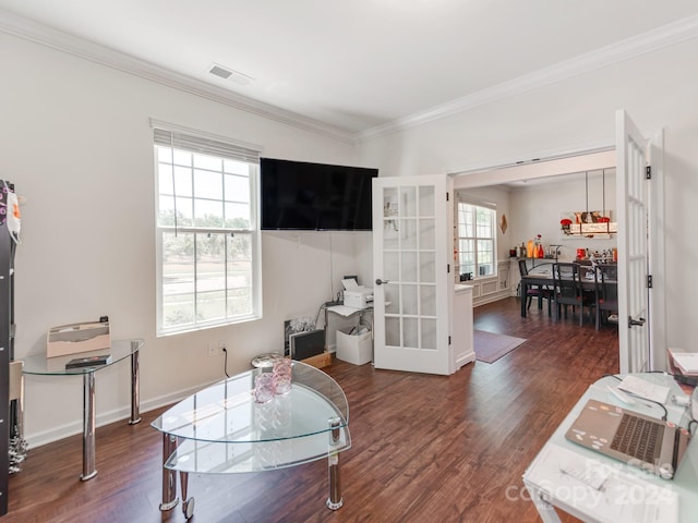 sitting room with a healthy amount of sunlight, dark hardwood / wood-style flooring, and crown molding