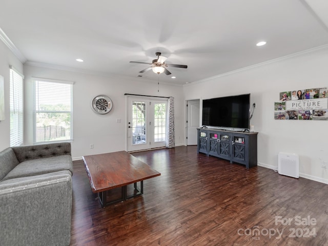 living room with dark wood-type flooring, a wealth of natural light, and ornamental molding