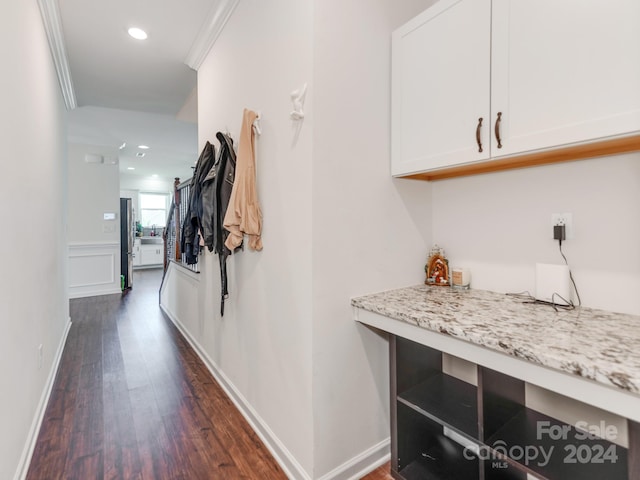 hallway featuring dark hardwood / wood-style floors and ornamental molding