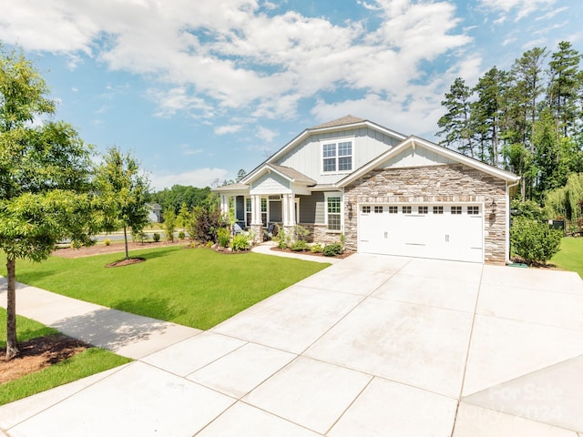 craftsman inspired home featuring a front yard, covered porch, and a garage