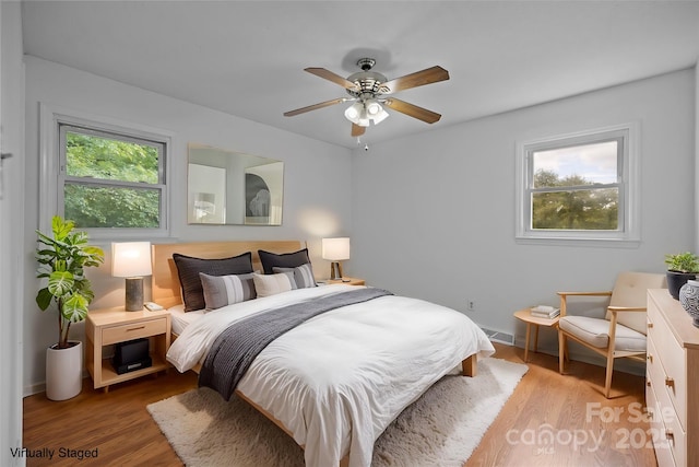 bedroom featuring ceiling fan and light hardwood / wood-style flooring