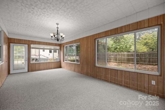 unfurnished sunroom featuring a chandelier