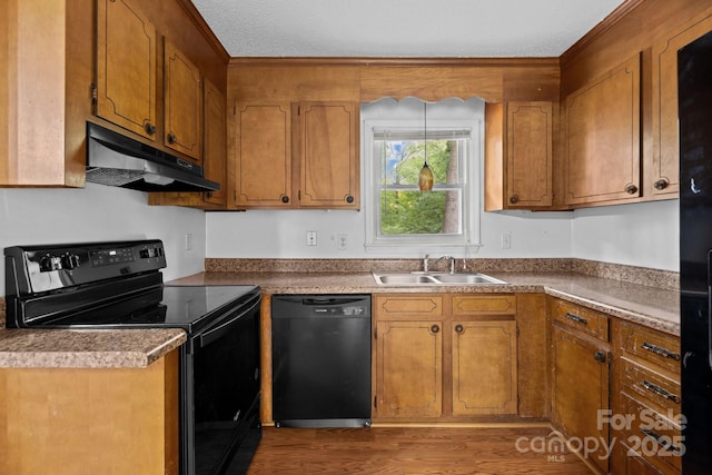 kitchen featuring wood-type flooring, sink, and black appliances