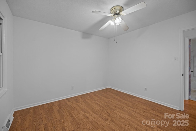 spare room with wood-type flooring and ceiling fan