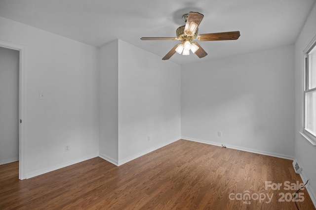 spare room featuring ceiling fan and dark hardwood / wood-style floors