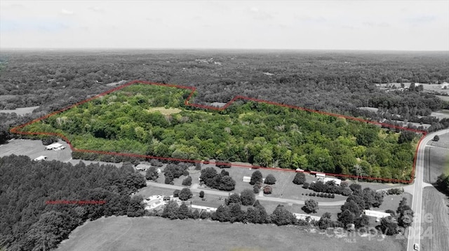 birds eye view of property with a wooded view