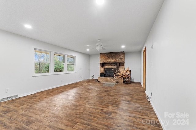 unfurnished living room featuring ceiling fan, a fireplace, and hardwood / wood-style flooring