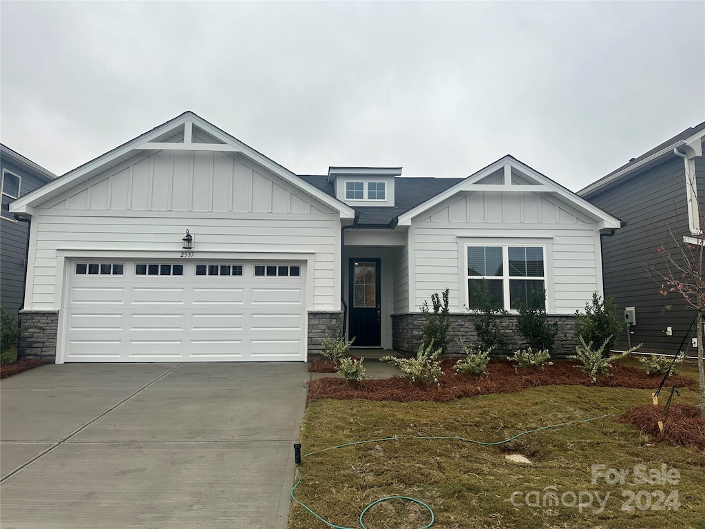 view of front of house with a garage and a front lawn