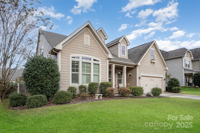 view of front of home featuring a garage and a front lawn