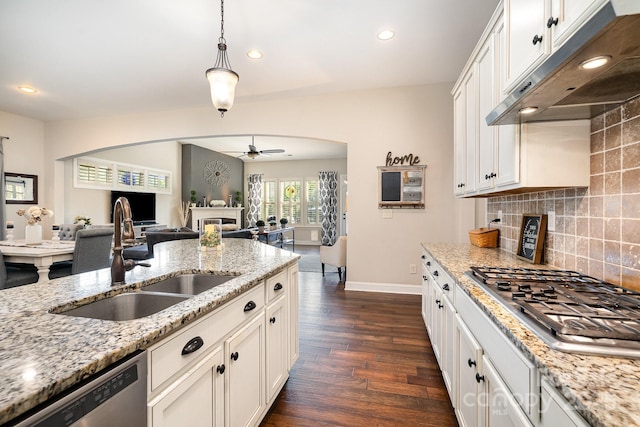 kitchen featuring sink, ceiling fan, light stone countertops, appliances with stainless steel finishes, and white cabinetry