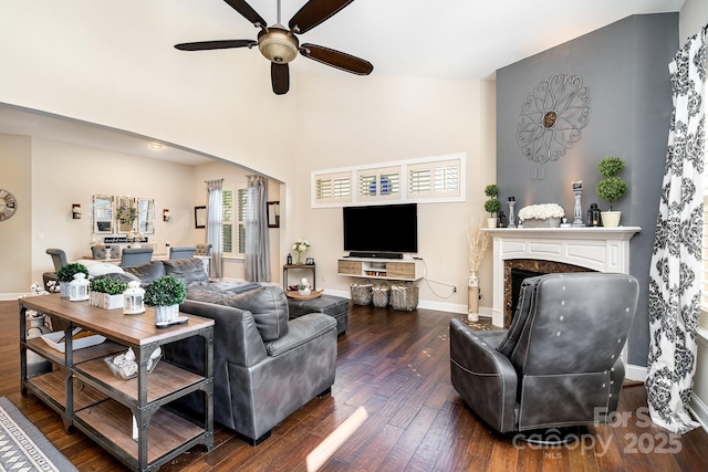 living room featuring a fireplace, dark hardwood / wood-style flooring, and ceiling fan