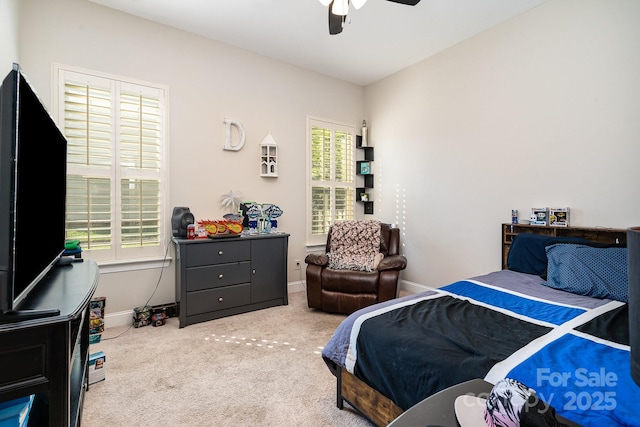 bedroom with carpet, multiple windows, and ceiling fan