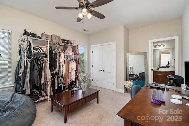 interior space with ceiling fan