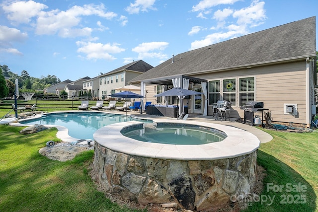 view of swimming pool with a patio area, a yard, an in ground hot tub, and grilling area