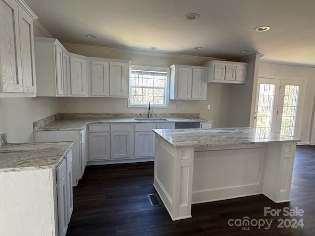 kitchen with dark hardwood / wood-style floors, white cabinetry, and sink