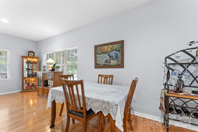 dining space with hardwood / wood-style flooring