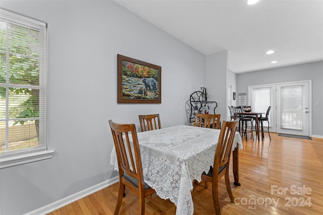 dining area featuring light wood-type flooring and plenty of natural light