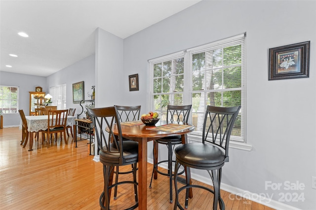 dining area with light hardwood / wood-style floors and a wealth of natural light