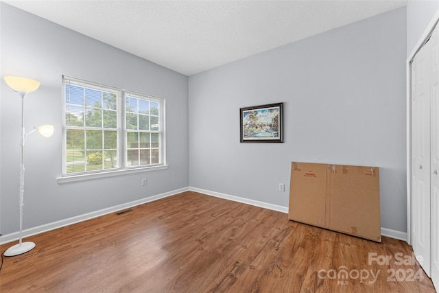 empty room featuring wood-type flooring