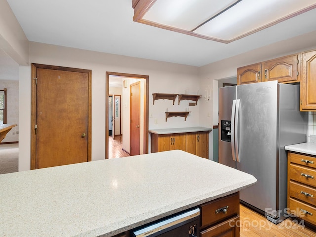 kitchen with stainless steel fridge and light hardwood / wood-style floors