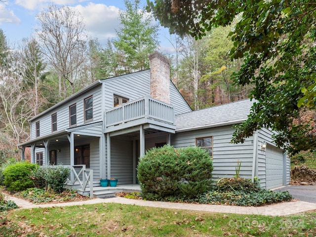 view of front of property with a porch and a garage