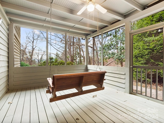 unfurnished sunroom with ceiling fan and a healthy amount of sunlight