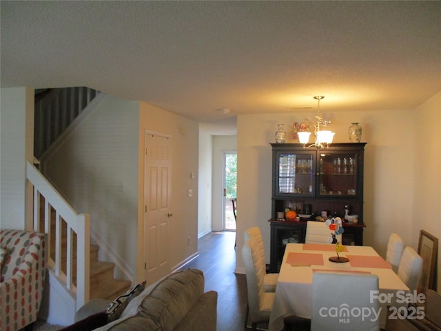 dining space with an inviting chandelier and hardwood / wood-style flooring