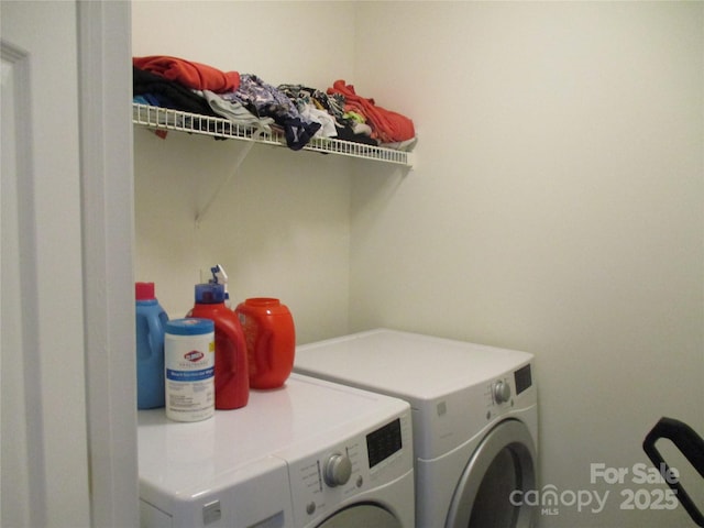 washroom with washing machine and clothes dryer