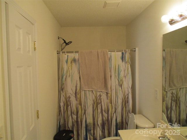 full bathroom featuring vanity, shower / bath combo, and toilet