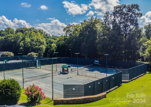 view of tennis court featuring fence