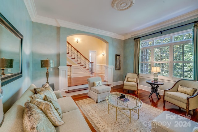 living room with hardwood / wood-style flooring and ornamental molding