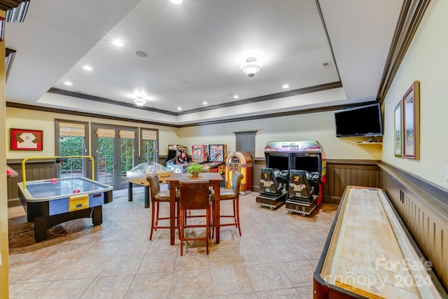 recreation room featuring crown molding, french doors, and a tray ceiling