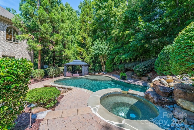 view of pool featuring a gazebo, a patio, and a pool with connected hot tub