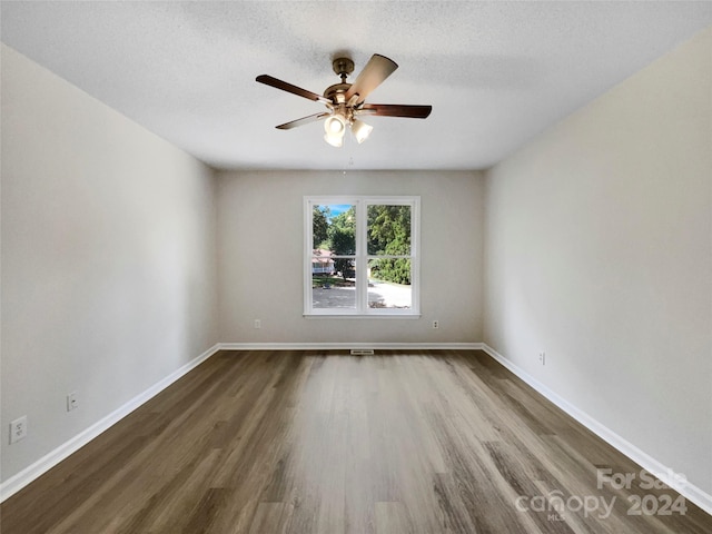 spare room with hardwood / wood-style flooring, a textured ceiling, and ceiling fan