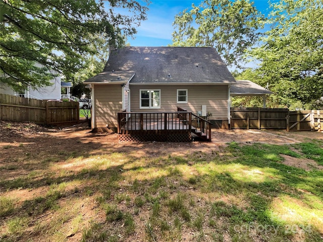 rear view of house featuring a yard and a wooden deck