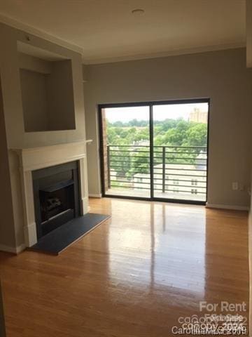 unfurnished living room featuring hardwood / wood-style flooring